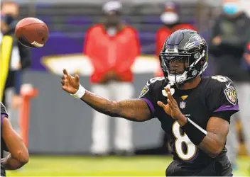  ?? PATRICK SMITH GETTY IMAGES ?? Ravens quarterbac­k Lamar Jackson became the highest-profile Baltimore player to test positive for COVID-19 and he won’t be able to play Sunday against the Steelers. The NFL hasn’t canceled the game yet.