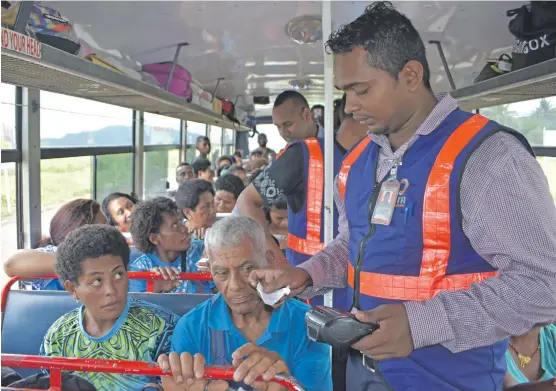 ?? Photo: Shratika Naidu ?? A Land Transport Authority officer checks passengers e-ticket receipts during a spot check in Labasa on January 11,2019.