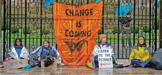  ?? ?? Gated community: Four activists from Extinction Rebellion locked themselves to the gates at the University of Glasgow