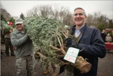  ?? SUBMITTED PHOTO ?? Pennsylvan­ia Agricultur­e Secretary Russell Redding helps kick off the state’s annual Trees for Troops effort at Bustard’s Christmas Trees on Friday.