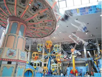  ??  ?? Galaxyland in the West Edmonton Mall boasts carnival rides for people of every age and thrill tolerance.