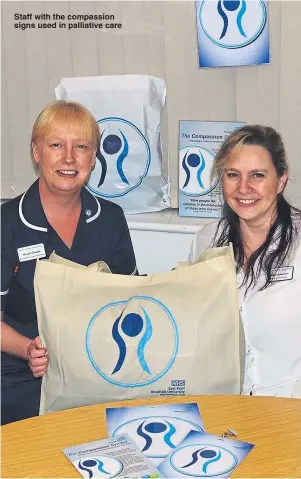  ??  ?? Staff with the compassion signs used in palliative care