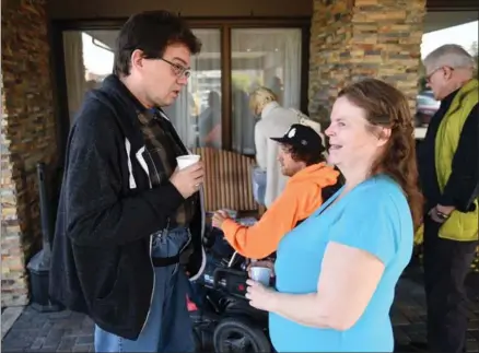  ?? DAVID BEBEE, RECORD STAFF ?? Kevin Bast, a resident of The Ark, talks to fellow resident Mona Neal outside of the Comfort Inn on Weber Street in Waterloo. They are among 24 people who have been staying at the hotel since water damage from a burst sprinkler head forced them out...