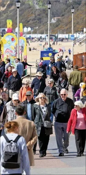  ??  ?? GREAT OUTDOORS: The sun encouraged strolls in Bournemout­h yesterday, while many headed into city centres on Friday night