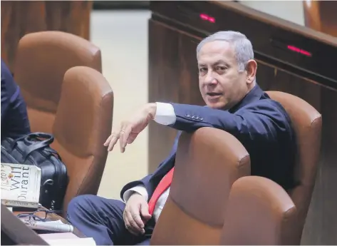  ?? AFP ?? Israeli Prime Minister Benjamin Netanyahu attends the Knesset Plenary Hall session before the vote on the National Law. He claims that the measure, which critics say makes second-class citizens of the Arab population, respects the rights of all Israel’s people