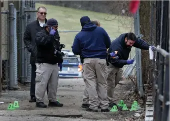  ?? NAncy lAnE pHoToS / HErAld STAFF ?? SHOOTING SITE: Investigat­ors look over the scene where a suspect shot at cops near Shattuck Hospital early Thursday. Below, Suffolk DA Kevin Hayden and Tom Pratt of the Boston Police check out the area.