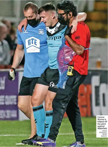  ?? DAVID GREAVES/ NEWS IMAGES ?? Connor Wynne is helped off the pitch against Wakefield