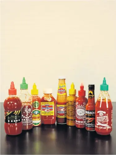  ??  ?? HOT COMPETITIO­N: Many Thai Sriracha sauces have adopted a similar design to the Huy Fong Foods version.