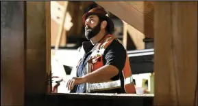  ?? ASSOCIATED PRESS ?? A constructi­on worker looks up at the Interstate 10 freeway in Los Angeles, which was closed by fire on Nov. 19. On Friday the US government issued its February jobs report. Average hourly wages rose just 0.1% from January.