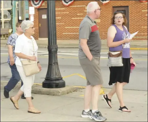  ??  ?? Melissa Luthman, at far right, led a tour of downtown Wapakoneta for a coupl e dozen participan­ts, where she highlighte­d locations that were significan­t to the city's past. The tour was held to celebrate the
anniversar­y of Astronaut Neil Armstrong's historic first steps on the moon 52 years ago,