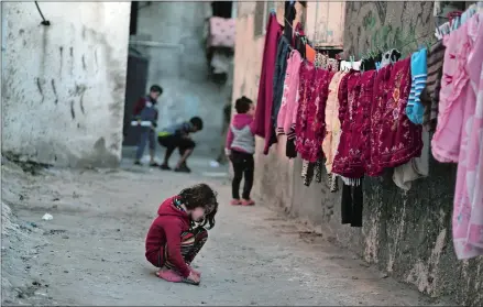  ?? KHALIL HAMRA/AP PHOTO ?? Palestinia­n children play in an alley at the Shati refugee camp in Gaza City in January.