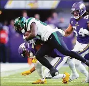  ?? Adam Bettcher / Getty Images ?? The Vikings' Akayleb Evans forces Jest running back Zonovan Knight out of bounds during the second quarter on Sunday in Minneapoli­s.