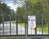  ?? The Sentinel-Record/Grace Brown ?? GARVAN CLOSES: A “closed” sign hangs on the front gate of Garvan Woodland Gardens on Tuesday.