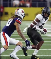  ?? ASSOCIATED PRESS FILE PHOTO ?? Oregon safety Jevon Holland (8) intercepts a pass in front of Auburn wide receiver Sal Cannella (80) during the first half of a 2019 game.