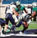  ?? Jack Warhola / Yale Athletics / ?? Yale running back Tre Peterson goes in from 2 yards out for a touchdown to give the Bulldogs a 24-7 lead over Dartmouth in the third quarter Saturday at Yale Bowl. Peterson rushed for 173 yards on 28 carries to lead Yale.