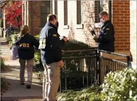  ?? ADAM CAIRNS/THE COLUMBUS DISPATCH VIA AP ?? FBI agents removing items from the German Village home of Public Utilities Commission of Ohio Chairman Sam Randazzo on Nov. 16, in Columbus, Ohio.