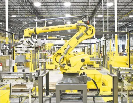  ?? BRYANANSEL­M/THE NEWYORKTIM­ES ?? A robot arm sorts bins onto pallets after they arrive on a conveyor belt in August 2017 at an Amazon warehouse in Florence, NewJersey. A task force assembled by the Massachuse­tts Institute of Technology has completed an extraordin­arily comprehens­ive effort to examine how technology has changed, and will change, the workforce.