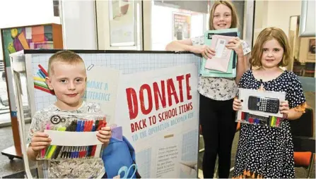  ?? Photo: Nev Madsen ?? SHOW OF SUPPORT: Handing over donations for Operation Backpack are (from left) Josiah, Tahli and Hannah Lorimer at Toowoomba Plaza.