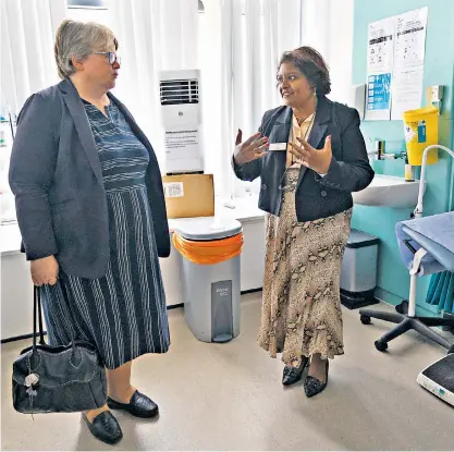  ?? ?? Thérèse Coffey, the Health Secretary, speaks to Dr Sheila Neogi during her visit to the Marven Surgery in London