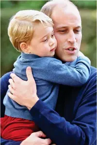  ??  ?? Big hug: Prince William with his son George