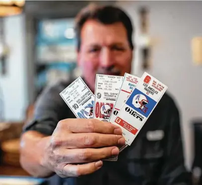  ?? Photos by Marie D. De Jesús / Staff photograph­er ?? Former Houston Oilers and Texans season-ticket holder John Work shows off tickets he saved from games in the ’80s and ’90s.