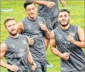  ??  ?? Mesut Ozil of Arsenal (C) warms up with teammates during a training session for the Internatio­nal Champions Cup in Singapore on Friday.