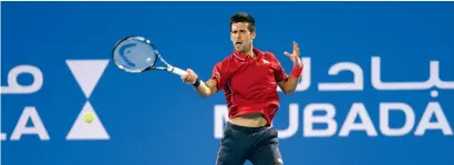  ?? Getty Images file ?? Djokovic hit a return against Wawrinka during the semifinal of the Mubadala World Tennis Championsh­ip 2015. —