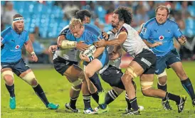  ?? /Anton Geyser/Gallo Images ?? Blue barrage: Adriaan Strauss barges his way through three Sunwolves players last week. Now the Bulls captain plans more of the same in New Zealand this weekend.