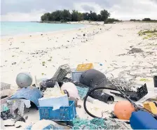  ?? CALEB JONES/2019 ?? Plastic and other debris litter a beach on Midway Atoll in the Pacific Ocean.