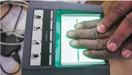  ?? PHOTO: REUTERS ?? A villager goes through the process of fingerprin­t scanning for the Unique Identifica­tion database system at an enrolment centre in Rajasthan. An individual’s match score differs every time because of multiple angles and hand pressure while matching...