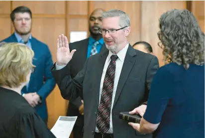  ?? MONICA CABRERA/THE MORNING CALL PHOTOS ?? Gavin P. Holihan is sworn in as Lehigh County district attorney by Senior Judge Carol K. McGinley at the Lehigh County Courthouse in Allentown. Holihan’s wife, Nancy, holds the Bible.