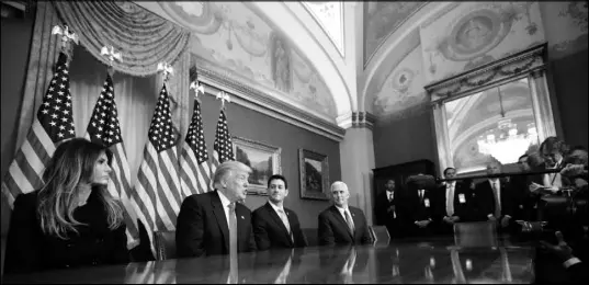  ?? ALEX BRANDON / AP ?? President-elect Donald Trump, second from left — accompanie­d by, from left, his wife, Melania; House Speaker Paul Ryan of Wisconsin and Vice President-elect Mike Pence — speaks to reporters Thursday after a meeting with Ryan in the speaker’s office on...