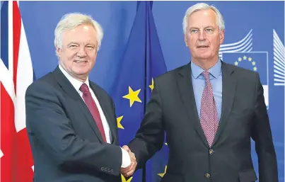  ??  ?? Brexit secretary David Davis and EU negotiator Michel Barnier.