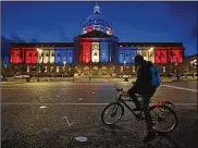  ?? JOSE CARLOS FAJARDO / BAY AREA NEWS GROUP 2020 ?? A bicyclist admires red, white and blue lights illuminati­ng San Francisco City Hall. Congress is beginning debate on the biggest overhaul of U.S. elections law in a generation.