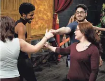  ?? ?? From left, Joshua Murray, Karam Alkhati, and Jacey Nichole on Nov. 28 rehearse a Regency Era dance for Oklahoma Shakespear­e in the Park's production of “Jane Austen's Christmas Cracker.”