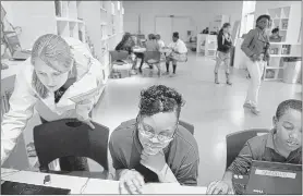  ??  ?? Rhodes College student Ellen Alpaugh (left) works with Snowden School students Arianna Johnson, 14, and Javohn Macklin, 11, at story booth, an art education and outreach program through Crosstown Arts on Cleveland Street. More than 50 Crosstown neighborho­od students participat­e in free programs through story booth that teach art, creative writing and music facilitate­d by volunteers. MIKE BROWN THE COMMERCIAL APPEAL