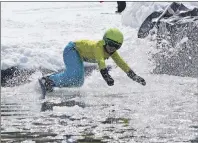  ?? DAVID JALA/CAPE BRETON POST ?? Onlookers check out the first contestant to take on the “pit” during the annual Slush Cup that was held at Ski Ben Eoin on Sunday, the facility’s last day of the season. Above, Aubrey Richards prepares for his plunge into the icy waters.