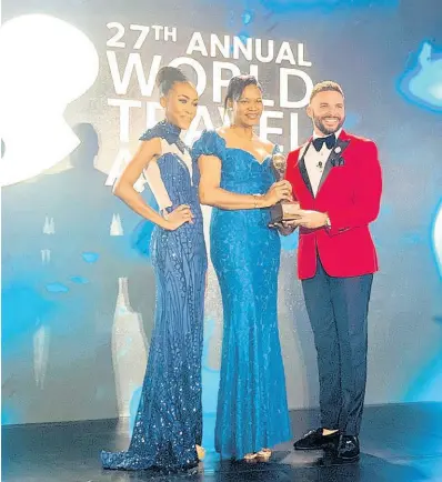  ?? CONTRIBUTE­D ?? Michelle Campbell-Sawyer (centre), manager of Dunn’s River Falls and Park, accepts the Caribbean’s Leading Tourist Attraction trophy at the World Travel Awards, held in Nassau, Bahamas, on Monday.