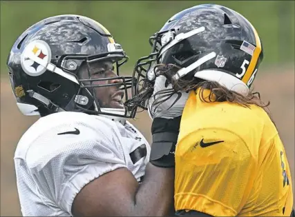  ?? Peter Diana/Post-Gazette ?? Offensive lineman Chukwuma Okorafor, battling Anthony Chickillo in drills at training camp, is starting the next stage of an athletic journey that has its roots on the soccer fields of Nigeria.