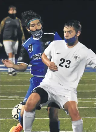  ?? PHOTOS BY JASON SCHMITT — FORMEDIANE­WS GROUP ?? Royal Oak’s Will Prothero (23) and Lakeland’s Ricky Beltran fight for the ball during their teams’ 2-2 tie Monday night at Lakeland High School.