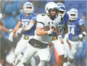  ??  ?? UCF quarterbac­k McKenzie Milton scrambles for the go-ahead touchdown against Memphis in the Knights’ 31-30 win in October. Milton will miss Saturday’s game because of a leg injury. JOE RONDONE/THE COMMERCIAL APPEAL