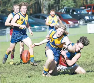  ??  ?? Warragul Industrial­s player Tyson Bale lays a tackle on Ellinbank’s Jaxon Notman