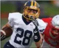  ?? DAVID TURBEN — THE NEWS-HERALD ?? Kirtland’s Luke Gardner runs for yards with Geneva’s Blake Peet in pursuit Sept. 7 during the Hornets’ 35-0 win.