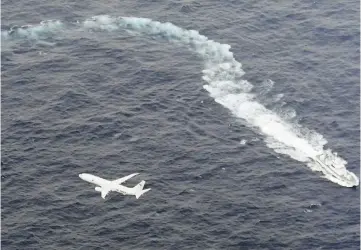  ??  ?? A Japan Coast Guard patrol vessel and US Navy airplane conduct search and rescue operation at the area where two US Marine Corps aircraft have been involved in a mishap in the skies, off the coast of Kochi prefecture, Japan, in this aerial view photo. — Reuters photo