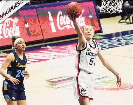  ?? David Butler II / USA Today ?? UConn’s Paige Bueckers (5) drives to the basket against Marquette on Monday night.