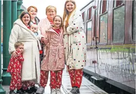  ?? ?? RAILWAY TREAT: The Keenan, above, and Peters families get set to board the Polar Express at Brechin. Pictures by Mhairi Edwards.