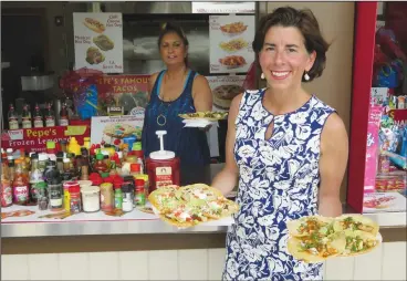  ??  ?? Above, Gov. Gina Raimondo and her staff enjoyed lunch from Pepe’s Kitchen during Friday’s stop. At left, Kelley Holmander, of Warwick, explains to Raimondo how hard it has been for her to get a job, going so far as to give the governor a copy of her resumé.