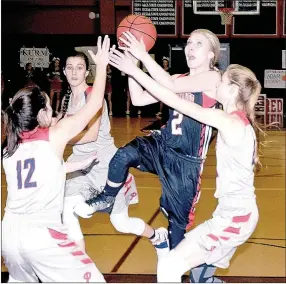 ?? PHOTO BY RICK PECK ?? McDonald County’s Caitylnn Sedillos drives against a pair of Providence Lady Patriots defenders to score two of her nine points in the Lady Mustangs 53-46 loss on Feb. 10 in Rogers.
