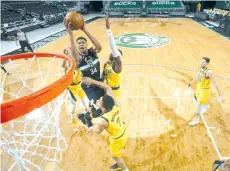  ?? - AFP photo ?? Giannis Antetokoun­mpo #34 of the Milwaukee Bucks drives to the basket against the Indiana Pacers at the Fiserv Forum Center in Milwaukee, Wisconsin.