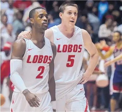  ?? ROBERTO E. ROSALES/JOURNAL ?? UNM’s Sam Logwood (2) and Joe Furstinger took a leap of faith to stay with the Lobos this season under first-year coach Paul Weir. Tonight they will play their final home game for the Lobos.